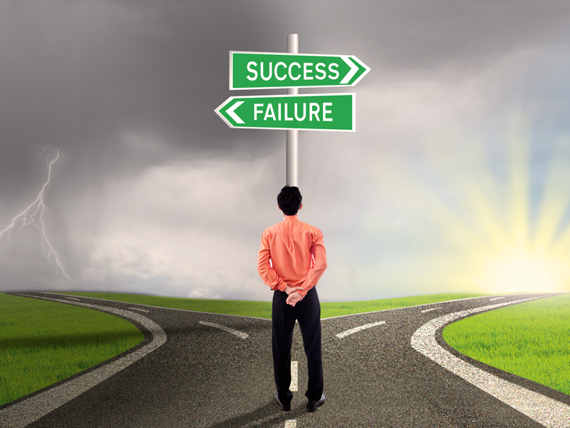Businessman at success and failure crossroads